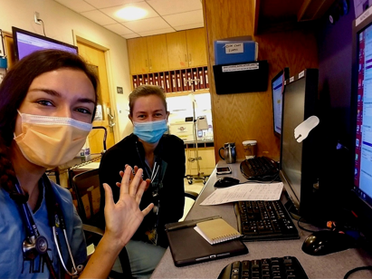 Rahael Borchers with a classmate at a desk at the Hospital of the University of Pennsylvania